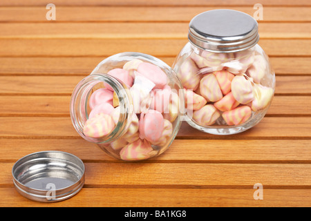 Pink marshmallows in two glass jar on wooden background Stock Photo