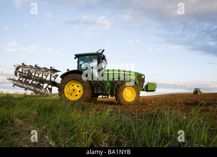 Two Tractors preparing agricultural land Stock Photo
