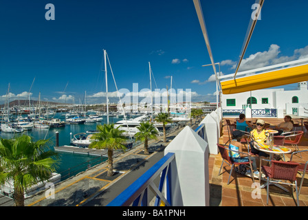Waterside restaurant in Marina Rubicon with people enjoying alfresco snack and drinks Lanzarote Canary Islands Spain Stock Photo