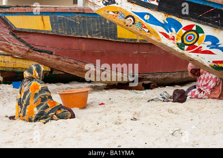 Woman on the Beach Next to Fishing Boats in Nouakchott Mauritania Stock Photo