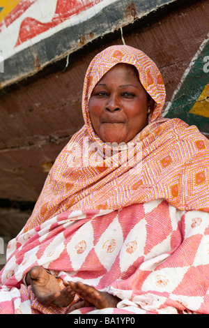Woman on the Beach Next to a Fishing Boat in Nouakchott Mauritania Stock Photo