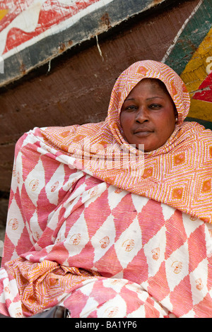 Woman on the Beach Next to a Fishing Boat in Nouakchott Mauritania Stock Photo