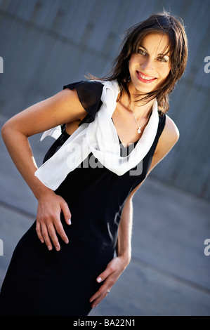 Elegant Woman dressed in black gown, happy, smiling Stock Photo