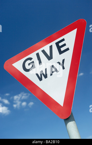 Give Way Sign Against A Blue Sky Stock Photo