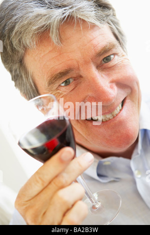 happy man drinking red wine from glass Stock Photo - Alamy