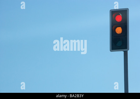 Red Traffic Light Set Against A Blue Sky Stock Photo