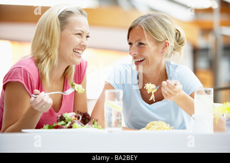 Female Friends Having Lunch Together At The Mall Stock Photo