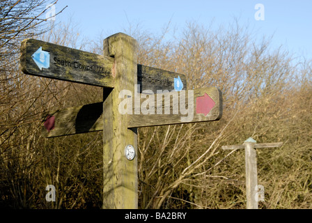 Wooden footpath sign pointing directions on the South Downs Way, Woolavington Down, West Sussex, England Stock Photo