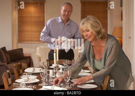 Couple Preparing Table For A Dinner Party Stock Photo
