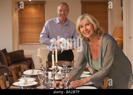 Couple Preparing Table For A Dinner Party Stock Photo