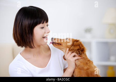 Young woman playing with Dachshund close up Stock Photo