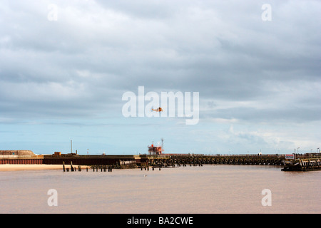 helicopter flying over harbour,great yarmouth harbour,norfolk Stock Photo