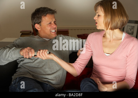 Couple Discussing Choice Of Television Channel Stock Photo