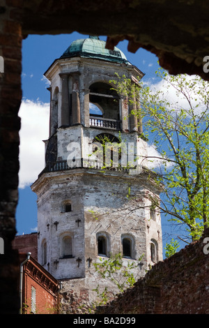 View on Vyborg clock tower through breach in wall. Stock Photo