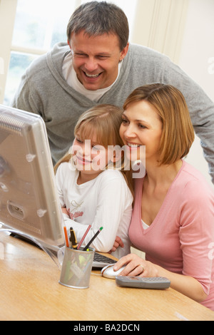 Couple And Daughter Using Computer Stock Photo
