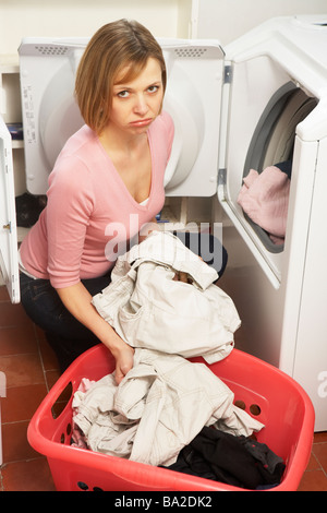 Unhappy Woman Doing Laundry Stock Photo