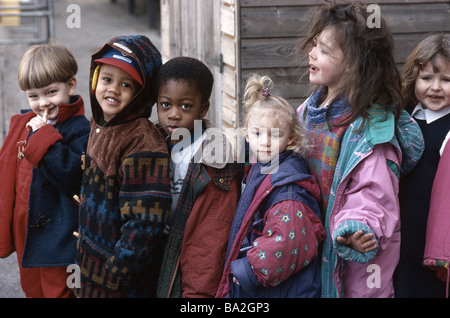 Multi-ethnic group of school children laughing and embracing Stock ...
