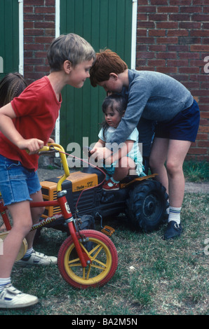 children playing in the yard including a child with Down s Syndrome Stock Photo