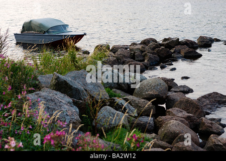 Old metal patrol boat moored near coast on sanrise. Stock Photo