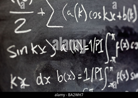 Close up of mathematical equations written on a blackboard in a classroom close up Stock Photo