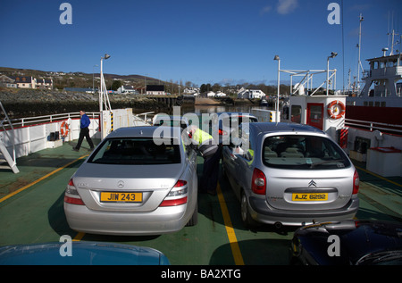 vehicles aboard the Foyle Venture small car and passenger ferry arriving in greencastle linking Magillian in County Derry Stock Photo