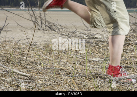 Woman young detail legs runs broached at the side shores people athletically movement runs activity sport fun dynamics power Stock Photo