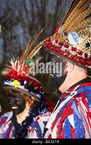 Morris Dancers wearing feathered hat with blacked up face Stock Photo