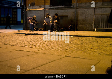 Buskers perform on a street corner in Temple Bar area of Dublin Ireland Stock Photo