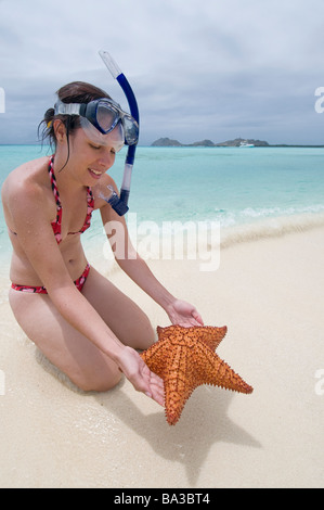 Woman snorkeler with Starfish Madrizqui Los Roques National park Venezuela South America Stock Photo