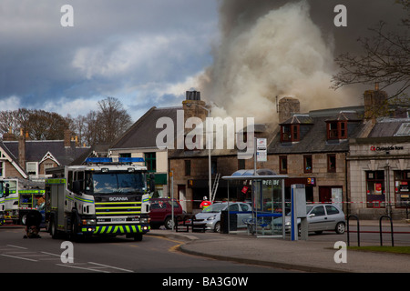 Firemen fighting Shop fire. Firefighter at scene at George Strachan’s of Aboyne, Aberdeenshire, Scotland Stock Photo