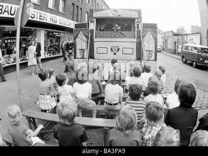 Seventies, black and white photo, kermess, people, children sitting in a Punch-and-Judy show, aged 4 to 8 years, Corpus Christi Kermess 1973, D-Oberhausen, D-Oberhausen-Sterkrade, Ruhr area, North Rhine-Westphalia Stock Photo