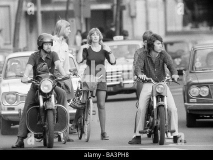 Seventies, black and white photo, road traffic, different traffic users waiting at red lights, motorbike, moped, bicycle, passenger cars, young men, young woman, teenagers, aged 18 to 35 years, Netherlands, Amsterdam Stock Photo