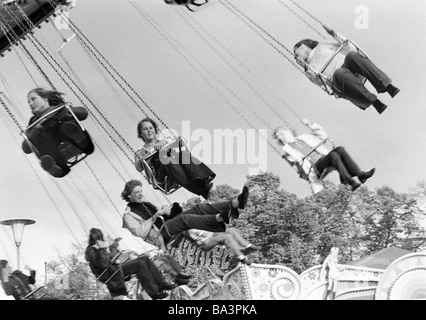 Seventies, black and white photo, kermess, people on a chairoplane Stock Photo