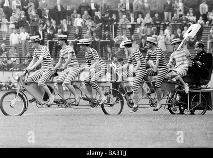 Sixties, black and white photo, event, 3rd International Police Sports and Music Festival 1966 in the Niederrhein Stadium in Oberhausen, humour, seven humorists on one bicycle, D-Oberhausen, Ruhr area, North Rhine-Westphalia Stock Photo