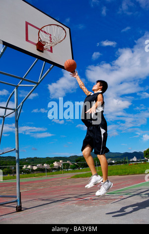 Teenage boy playing basketball Stock Photo
