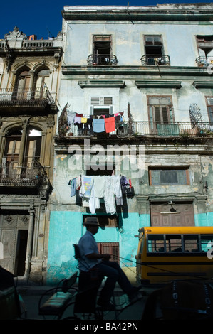 CUBA Havana Central town house with washing drying and local school bus in front March 2009 Stock Photo