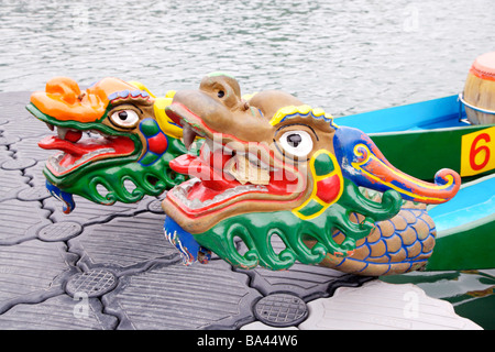 Dragon boats moored at waterside Stock Photo