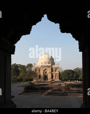 New Delhi's Lodhi Gardens shows the tomb Sheesh Gumbad viewed from the rear arch of the Bara Gumbad mosque set amid the grounds Stock Photo