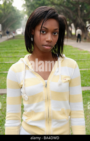 Young Woman Standing In Park Portrait Stock Photo