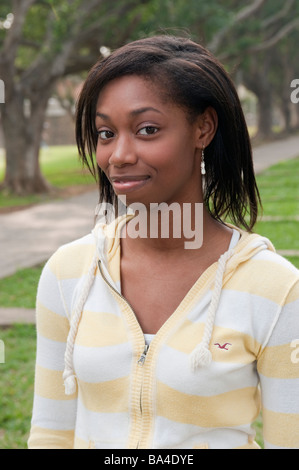 Young Woman In Park Smiling Portrait Stock Photo