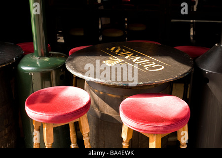table and two stools outside pub in London Stock Photo