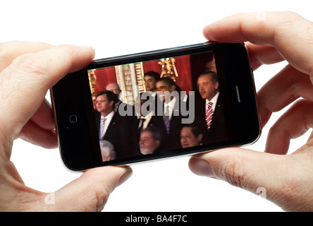 Male hands holding iPhone watching a video clip Stock Photo