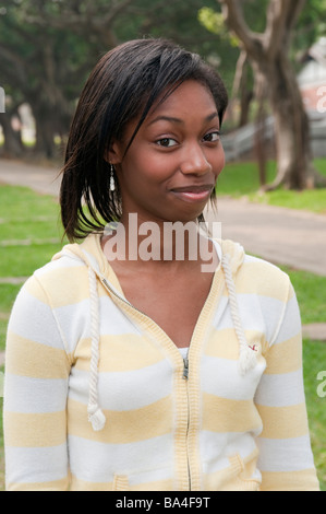 Young Woman In Park Smiling Portrait Stock Photo