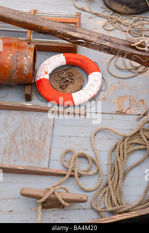 The deck of a boat with a life saving ring and rope on board Stock Photo