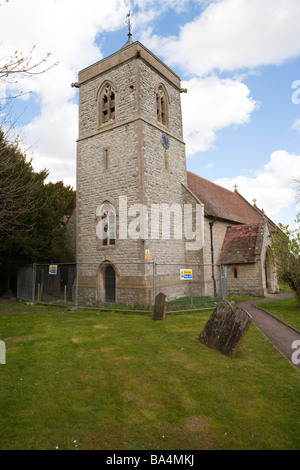 Church tower with a fence and 'Danger - Keep out' sign in front Stock Photo