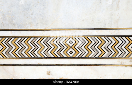 A repeating pattern made from semi precious stones inlaid in white marble. Taj Mahal, Agra, Uttar Pradesh, Republic of  India. Stock Photo