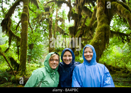 Mother and daughters posing for a portrait in the rain in the Hoh Rainforest Olympic National Park Washington USA Stock Photo