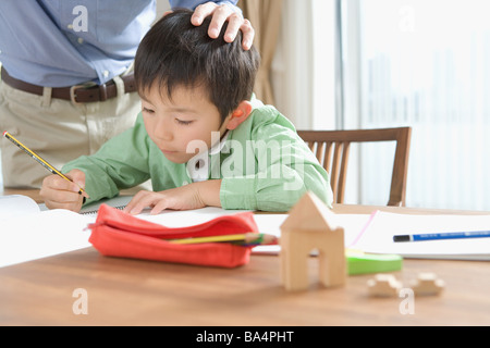 Japanese boy doing his homework Stock Photo