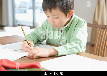 Japanese boy doing his homework Stock Photo