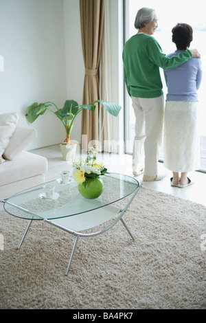 Senior couple standing in front door Stock Photo